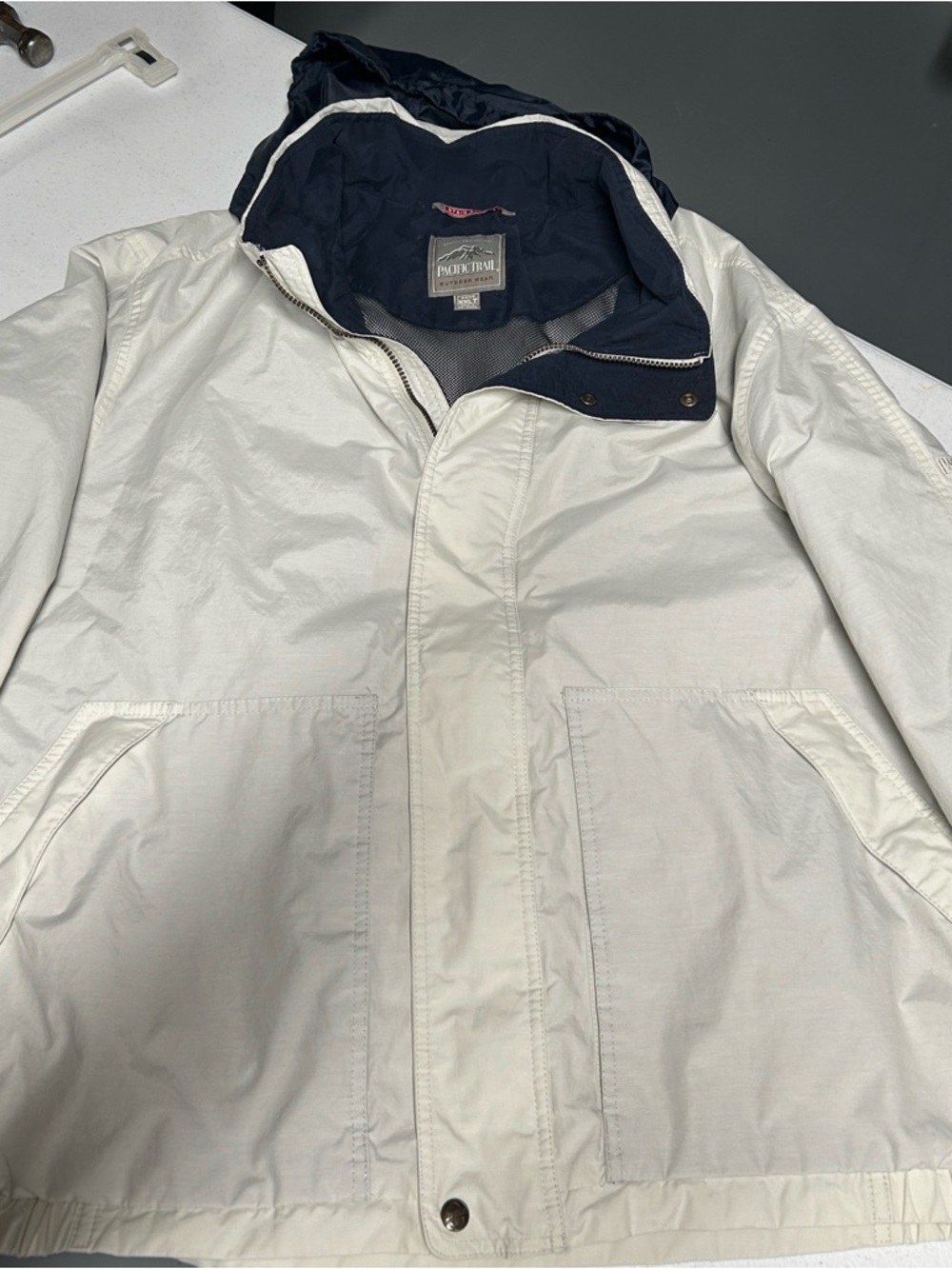 Pacific Trail Hooded Rain jacket with Navy Lining and hood rolled into collar